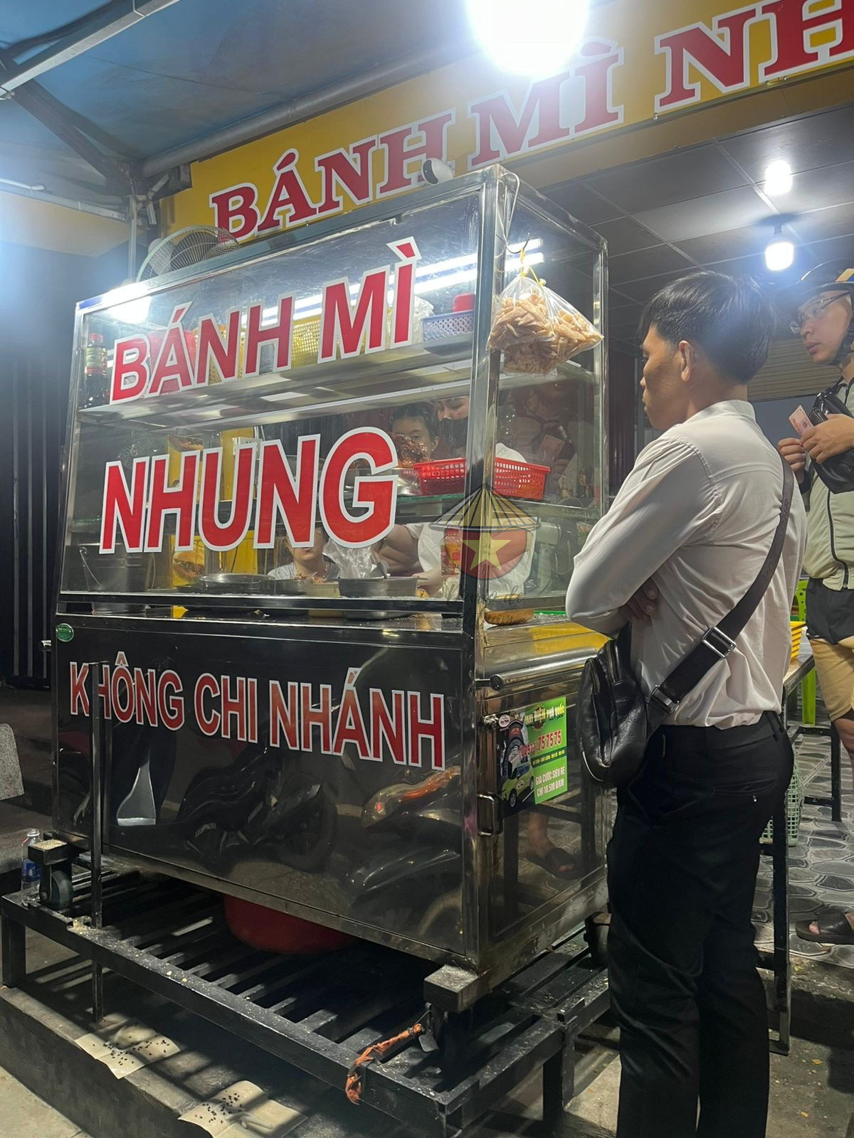 Otro punto de vista del puesto de Banh Mi Clientes esperando a recoger la comida